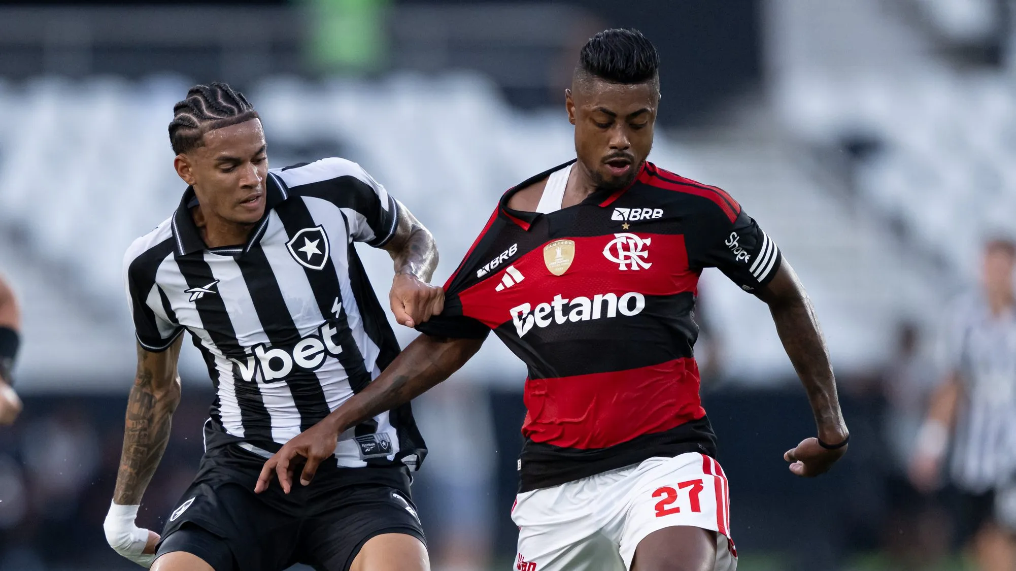 Newton jogador do Botafogo disputa lance com Bruno Henrique jogador do Flamengo durante partida pelo Carioca 2026. Foto: Jorge Rodrigues/AGIF