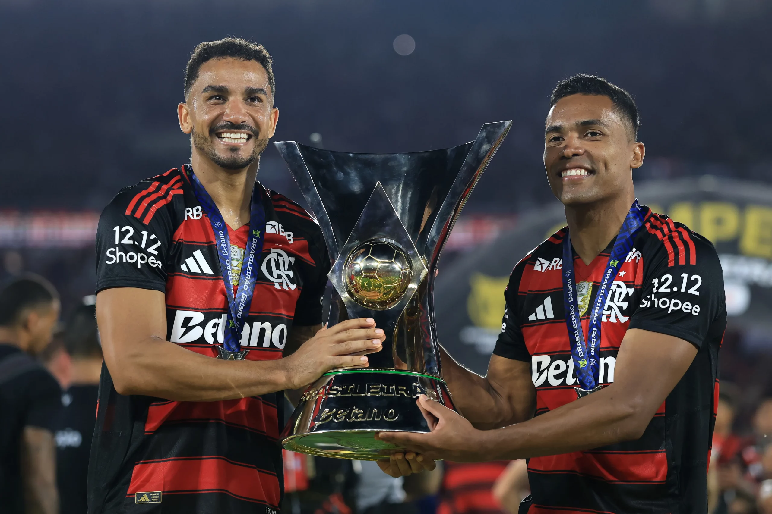 RIO DE JANEIRO, BRAZIL – DECEMBER 03: Danilo and Alex Sandro of Flamengo celebrate with the trophy after winning the championship following the Brasileirao 2025 match between   Flamengo and Ceara at Maracana Stadium on December 03, 2025 in Rio de Janeiro, Brazil. (Photo by Buda Mendes/Getty Images)
