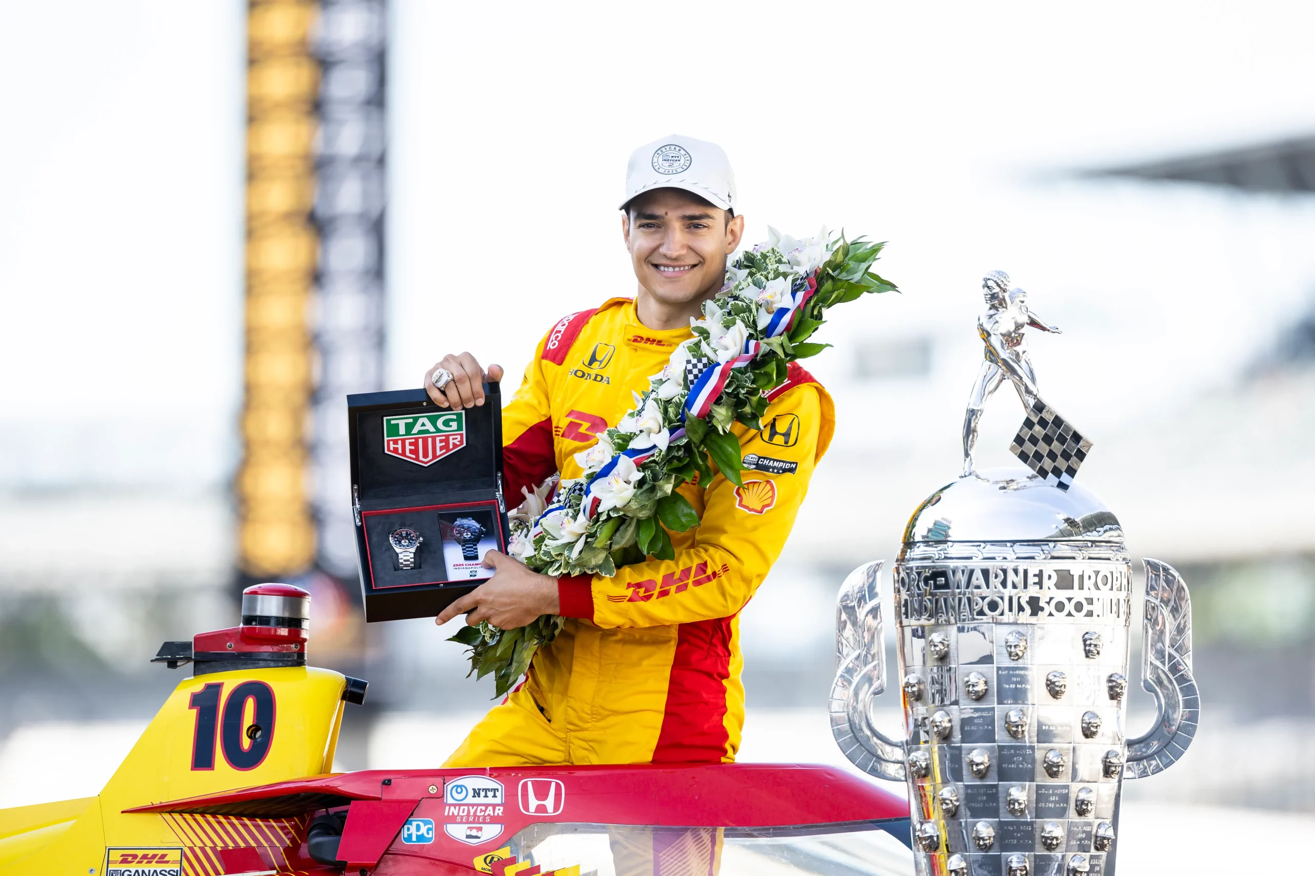 INDIANAPOLIS, INDIANA – MAY 26: Alex Palou, driver of the #10 DHL Chip Ganassi Racing Honda, poses for a photo with the Tag Heuer winner’s watch during the winner’s photo shoot for the NTT IndyCar Series 109th Running Of The Indianapolis 500 at Indianapolis Motor Speedway on May 26, 2025 in Indianapolis, Indiana. (Photo by James Gilbert/Getty Images)