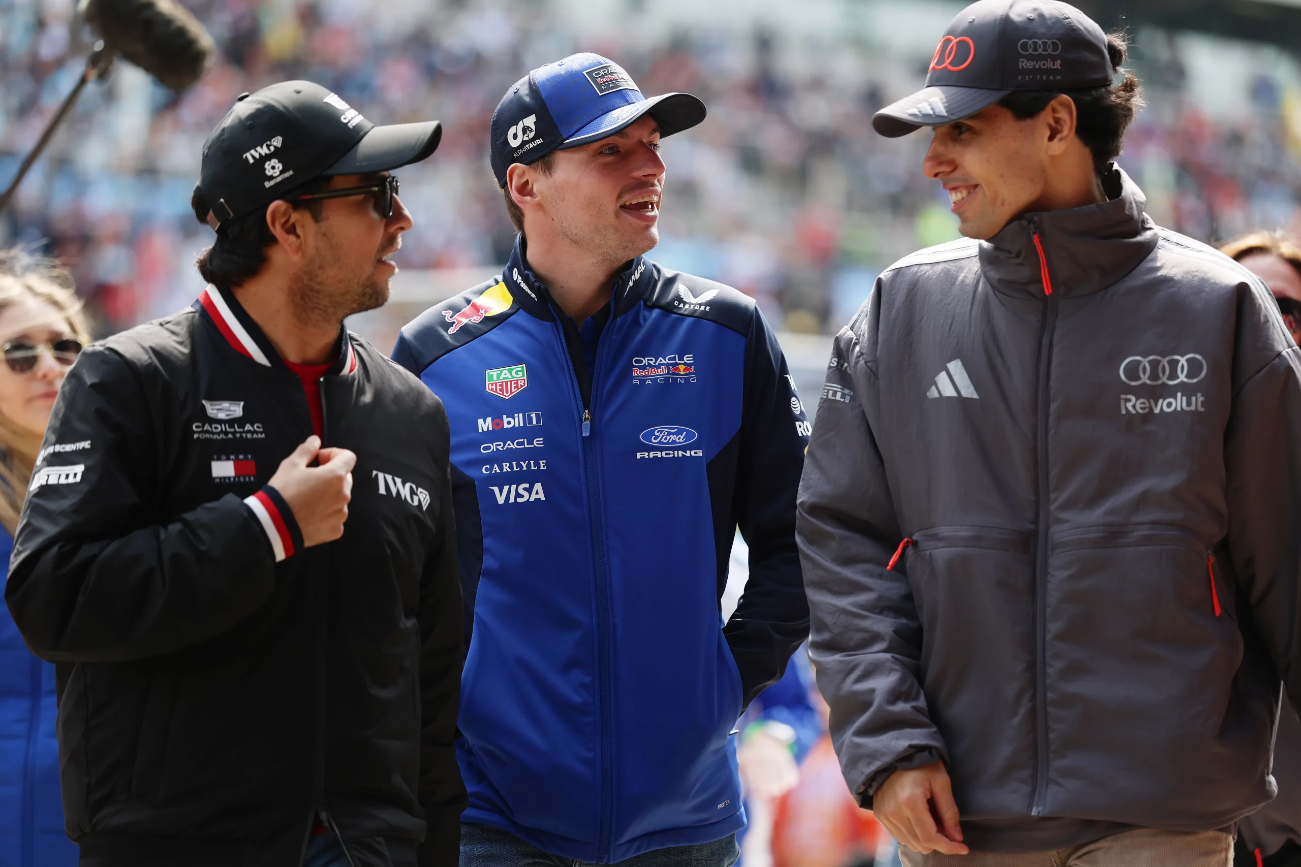 SHANGHAI, CHINA – MARCH 15: Sergio Perez of Mexico and Cadillac F1 Team Max Verstappen of the Netherlands and Oracle Red Bull Racing and Gabriel Bortoleto of Brazil and Audi F1 Team talk on the drivers parade prior to the F1 Grand Prix of China at Shanghai International Circuit on March 15, 2026 in Shanghai, China. (Photo by Mark Thompson/Getty Images)