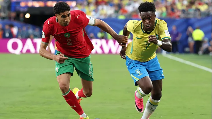 EAST RUTHERFORD, NEW JERSEY - JUNE 13: Achraf Hakimi #2 of Morocco competes for the ball against Vinicius Junior #7 of Brazil during the FIFA World Cup 2026 Group C match between Brazil and Morocco at New York New Jersey Stadium on June 13, 2026 in East Rutherford, New Jersey. (Photo by Darrian Traynor/Getty Images)