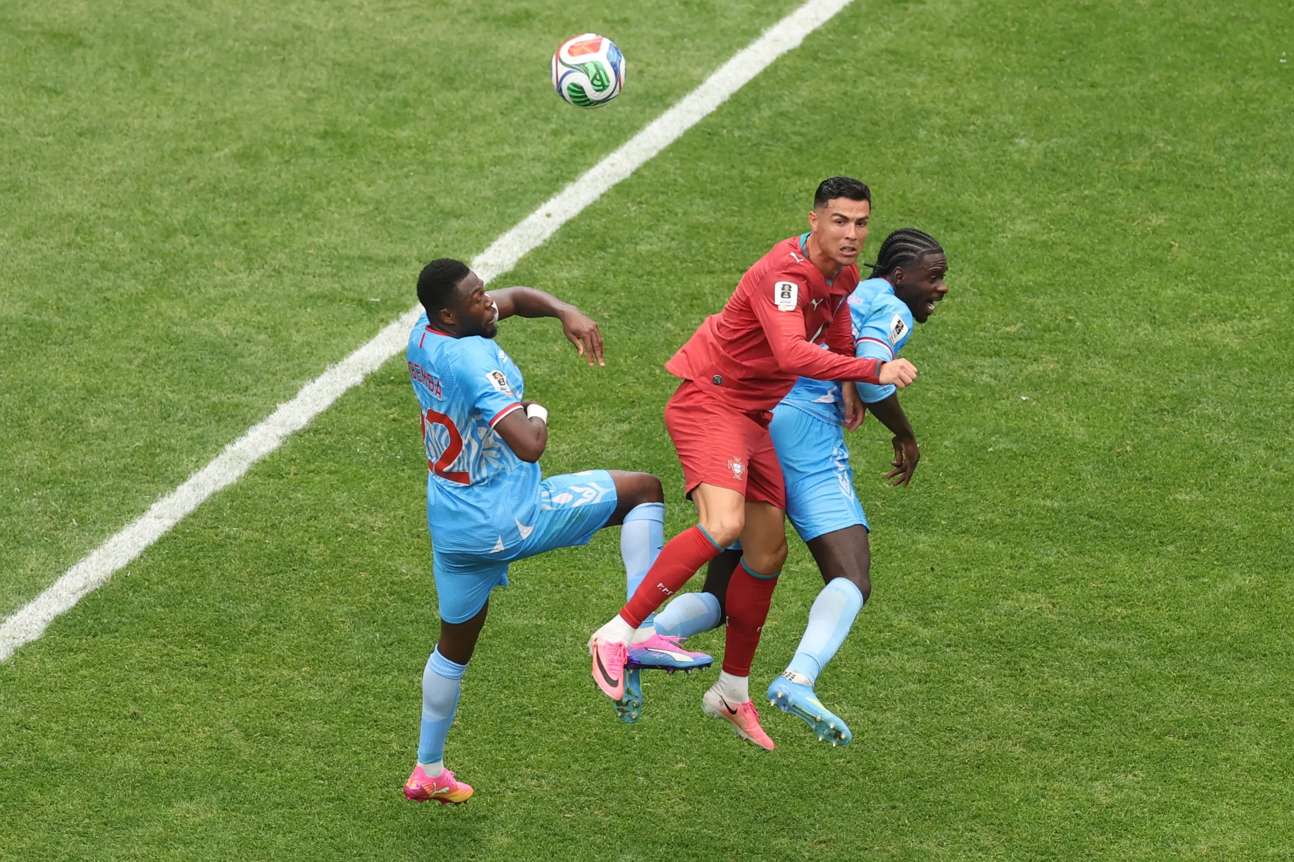 HOUSTON, TEXAS – JUNE 17: Cristiano Ronaldo #7 of Portugal competes for a header against Chancel Mbemba #22 and Axel Tuanzebe #4 of Congo DR during the FIFA World Cup 2026 Group K match between Portugal and Congo DR at Houston Stadium on June 17, 2026 in Houston, Texas. (Photo by Lars Baron/Getty Images)