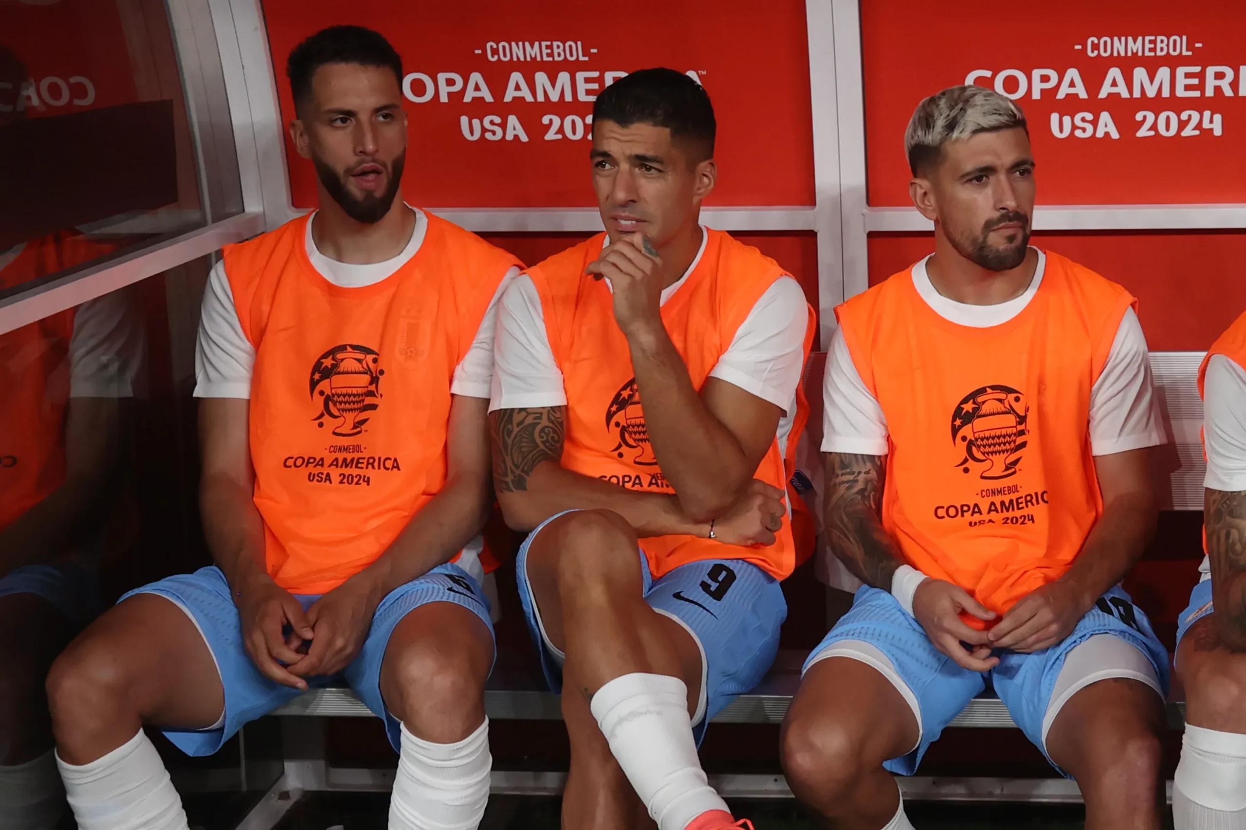 EAST RUTHERFORD, NEW JERSEY – JUNE 27: Luis Suarez of Uruguay (C) and teammates Rodrigo Bentancur (L) and Giorgian De Arrascaeta (R) sit in the bench prior to the CONMEBOL Copa America 2024 Group C match between Uruguay and Bolivia at MetLife Stadium on June 27, 2024 in East Rutherford, New Jersey. (Photo by Tim Nwachukwu/Getty Images)