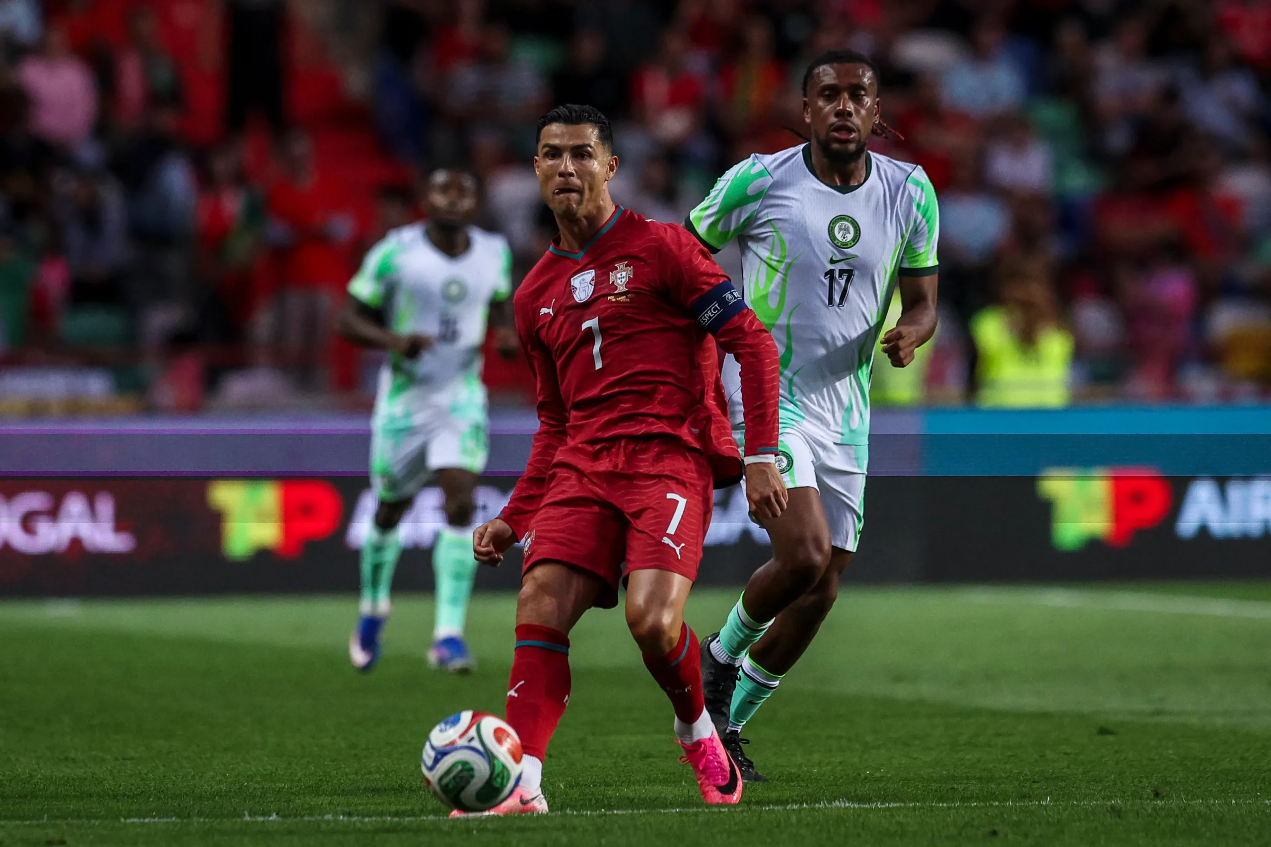 LEIRIA, PORTUGAL – JUNE 10: Cristiano Ronaldo of Portugal (R) tries to escape Alex Iwobi of Nigeria (L) during the International Friendly match between Portugal and Nigeria at Estadio Dr Magalhaes Pessoa on June 10, 2026 in Leiria, Portugal. (Photo by Carlos Rodrigues/Getty Images)