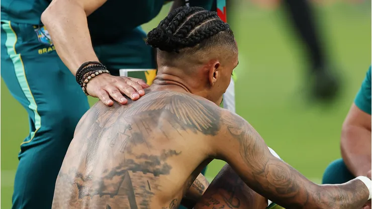 EAST RUTHERFORD, NEW JERSEY - JUNE 13: Raphinha #11 of Brazil is attended to by team staff after the 1-1 draw during the FIFA World Cup 2026 Group C match between Brazil and Morocco at New York New Jersey Stadium on June 13, 2026 in East Rutherford, New Jersey. (Photo by Darrian Traynor/Getty Images)