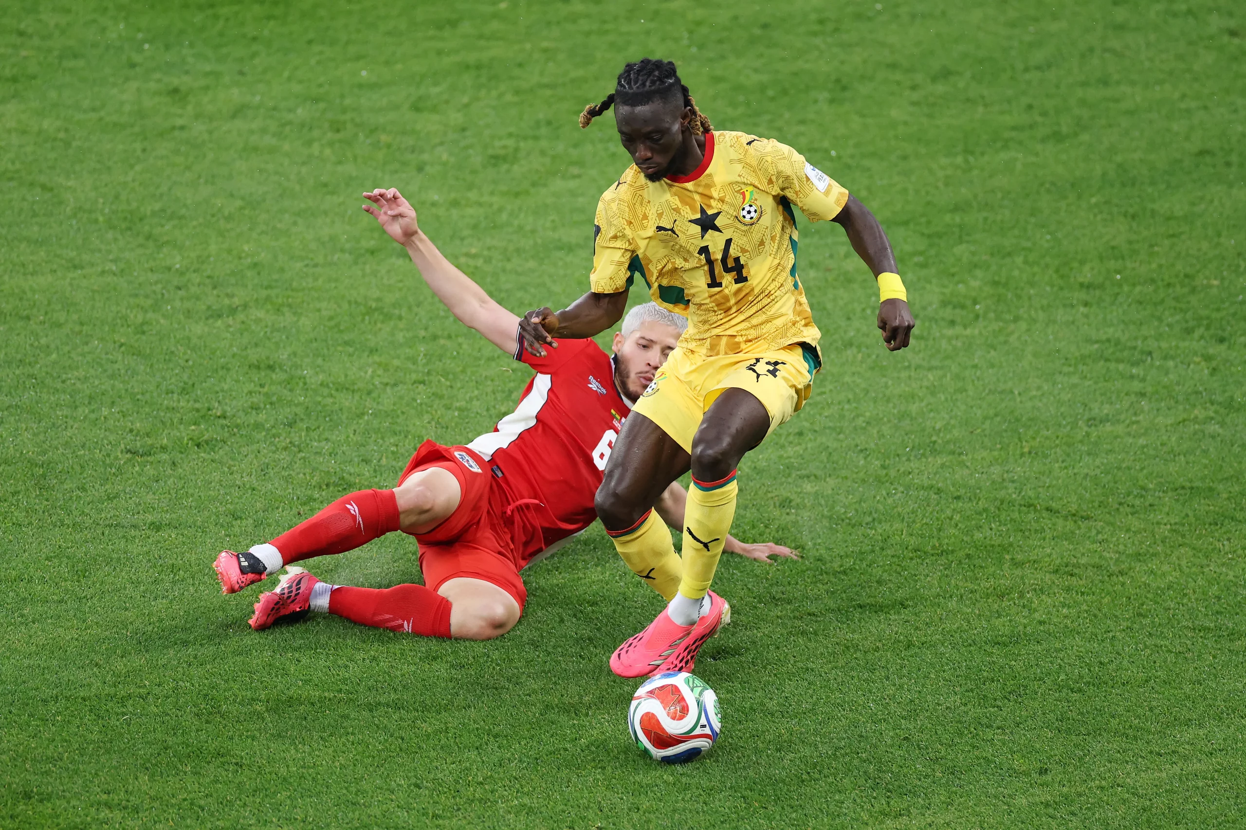 TORONTO, ONTARIO – JUNE 17: Gideon Mensah #14 of Ghana is  tackled by Cristian Martinez #6 of Panama during the FIFA World Cup 2026 Group L match between Ghana and Panama at Toronto Stadium on June 17, 2026 in Toronto, Ontario. (Photo by Dan Mullan/Getty Images)