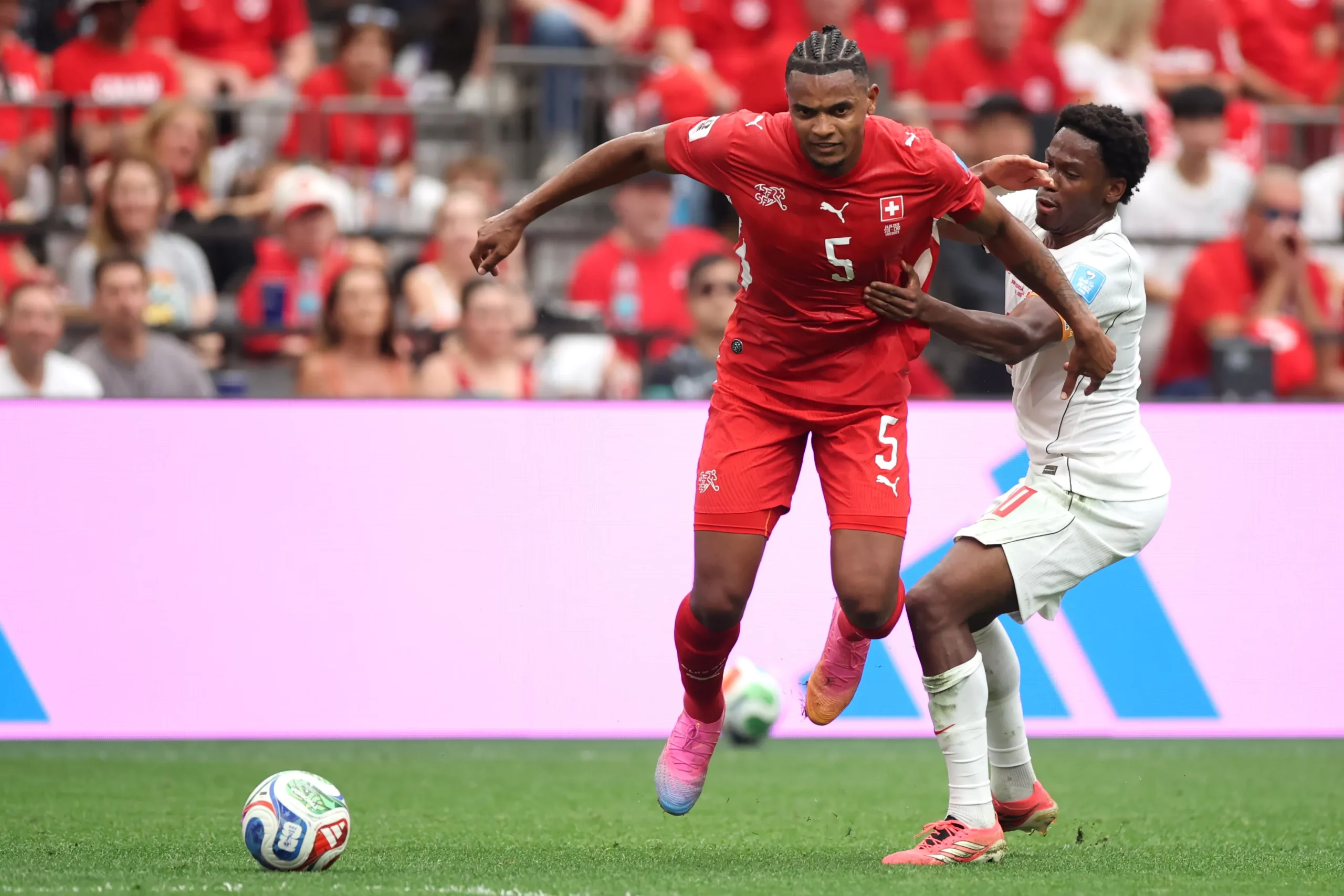 VANCOUVER, BRITISH COLUMBIA – JUNE 24: Manuel Akanji #5 of Switzerland controls the ball against Jonathan David #10 of Canada during the FIFA World Cup 2026 Group B match between Switzerland and Canada at BC Place Vancouver on June 24, 2026 in Vancouver, British Columbia. (Photo by Alex Grimm/Getty Images)