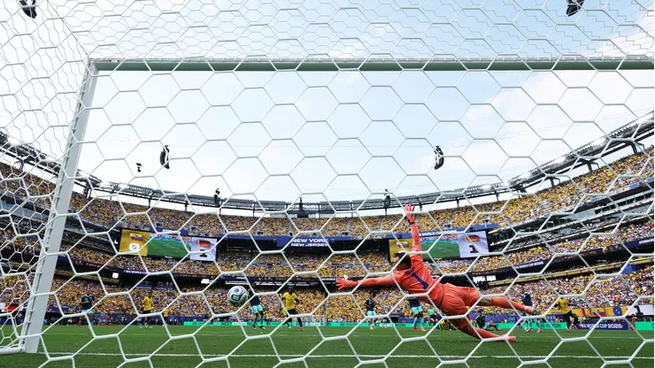 EAST RUTHERFORD, NEW JERSEY - JUNE 25: (EDITOR'S NOTE: Image was captured using a remote camera from behind the goal.) Manuel Neuer #1 of Germany dives to make a save during the FIFA World Cup 2026 Group E match between Ecuador and Germany at New York New Jersey Stadium on June 25, 2026 in East Rutherford, New Jersey. (Photo by Buda Mendes/Getty Images)