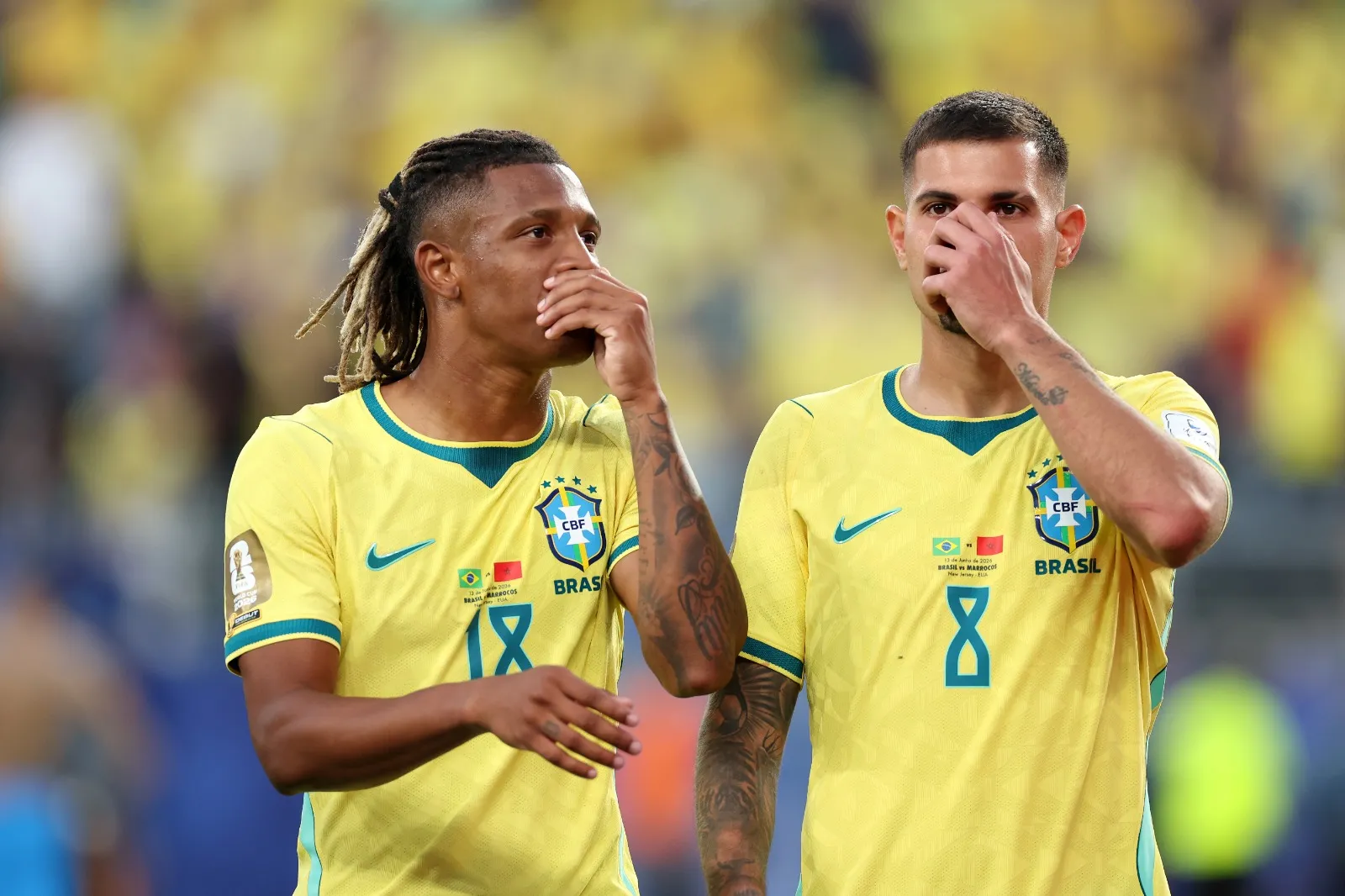 EAST RUTHERFORD, NEW JERSEY – JUNE 13: Danilo Santos #18 and Bruno Guimaraes #8 of Brazil cover their mouths to talk following the FIFA World Cup 2026 Group C match between Brazil and Morocco at New York New Jersey Stadium on June 13, 2026 in East Rutherford, New Jersey. (Photo by Dan Mullan/Getty Images)