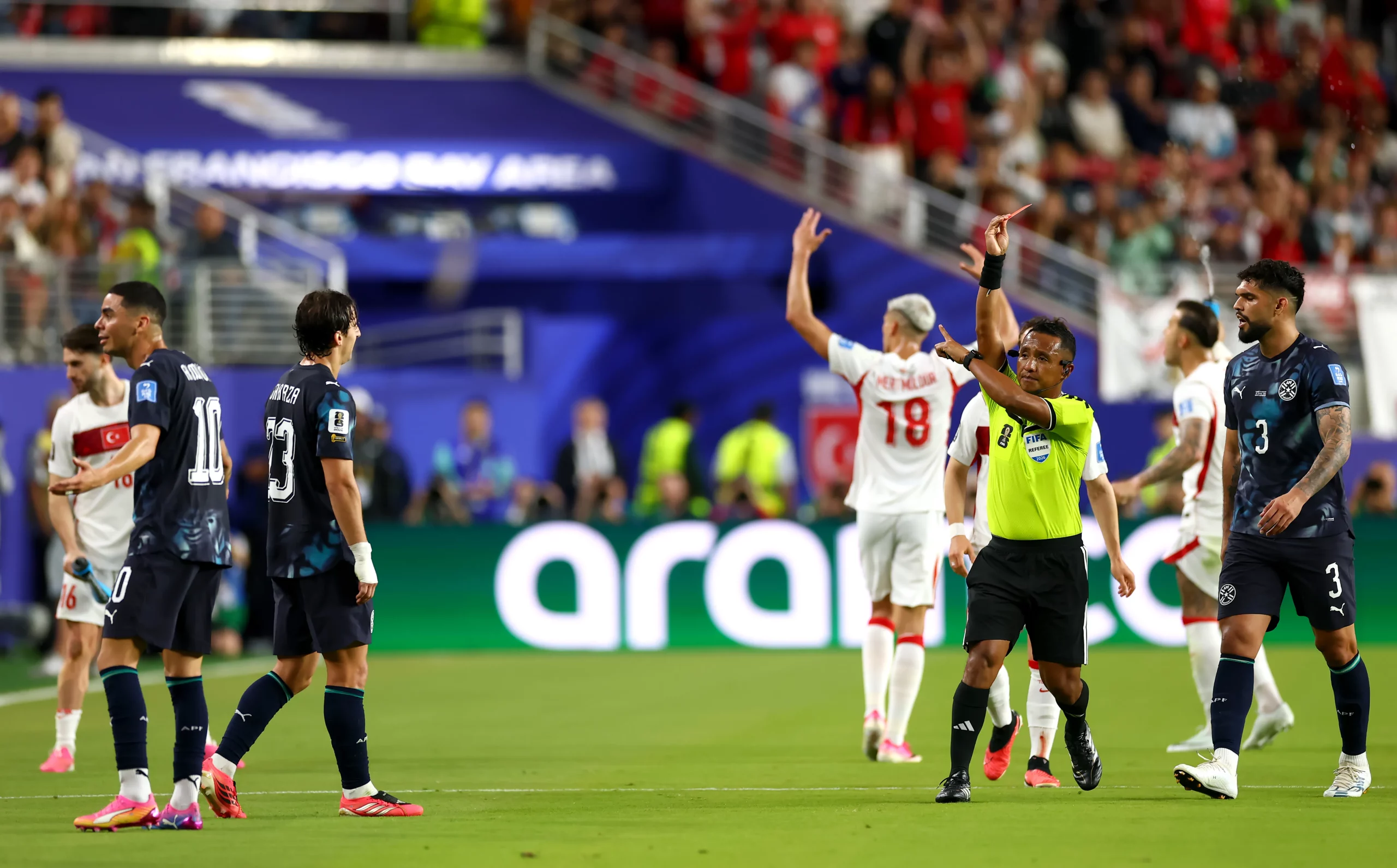 SANTA CLARA, CALIFORNIA – JUNE 19: Referee Ivan Barton issues a red card to Miguel Almiron #10 of Paraguay for covering his mouth while talking to another player during the FIFA World Cup 2026 Group D match between Türkiye and Paraguay at San Francisco Bay Area Stadium on June 19, 2026 in Santa Clara, California. (Photo by Dean Mouhtaropoulos/Getty Images)