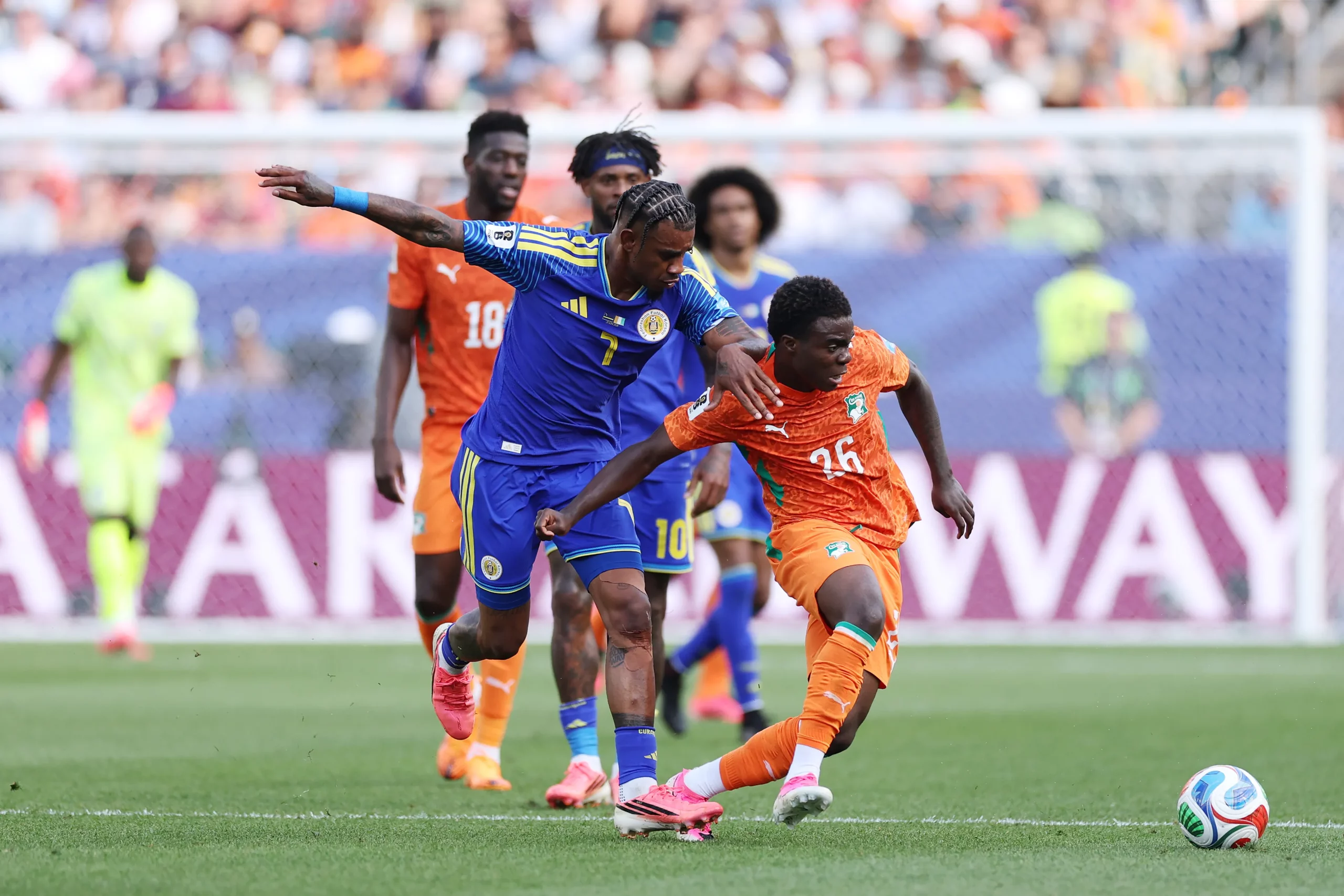 PHILADELPHIA, PENNSYLVANIA – JUNE 25: Christ Inao Oulai #26 of Cote d’Ivoire is fouled by Juninho Bacuna #7 of Curacao during the FIFA World Cup 2026 Group E match between Curacao and Cote D’Ivoire at Philadelphia Stadium on June 25, 2026 in Philadelphia, Pennsylvania. (Photo by Kevin C. Cox/Getty Images)