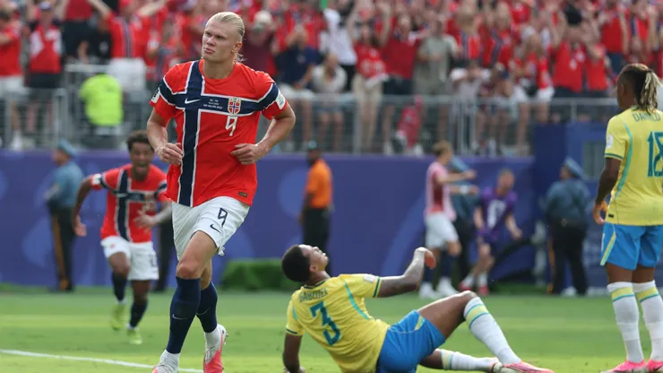 EAST RUTHERFORD, NEW JERSEY - JULY 05: Erling Haaland #9 of Norway celebrates after scoring his team's first goal while Gabriel Magalhaes #3 of Brazil shows dejection during the FIFA World Cup 2026 Round of 16 match between Brazil and Norway at New York New Jersey Stadium on July 05, 2026 in East Rutherford, New Jersey. (Photo by Al Bello/Getty Images)